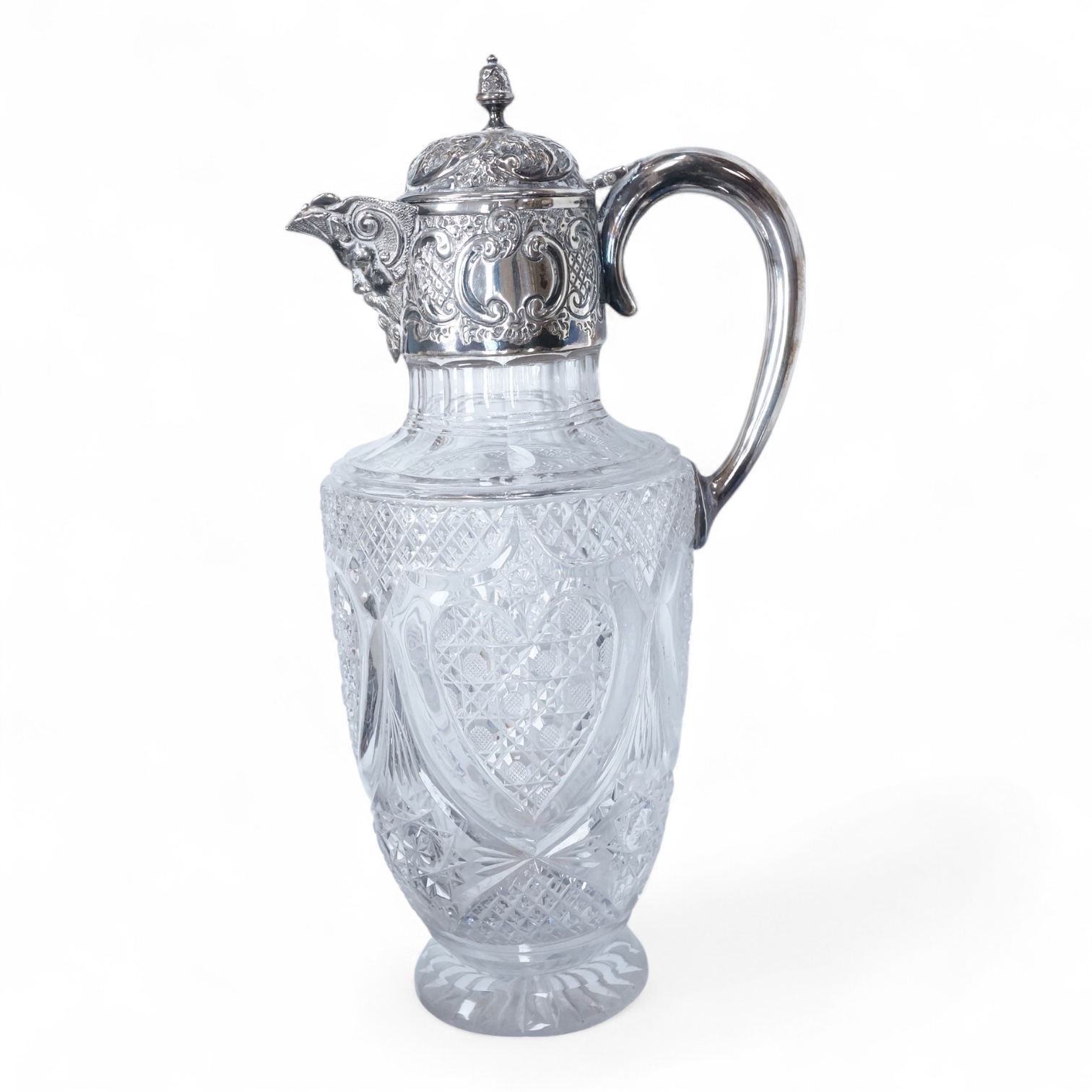 A late Victorian silver mounted cut glass claret jug, by Henry Wigfull, Sheffield, 1897, with mask spout and decorated with foliage and scrolls, height 27.5cm.